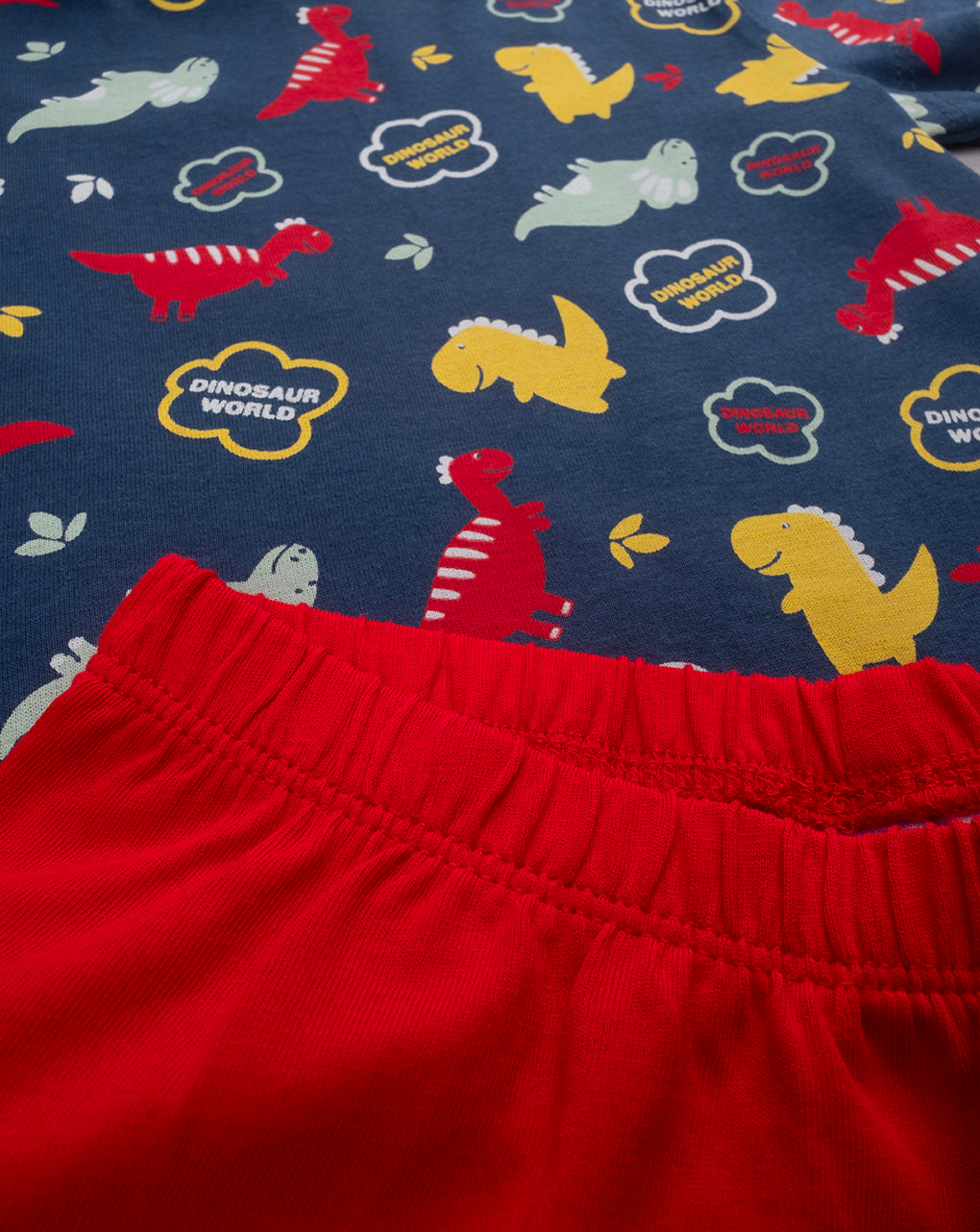Pigiama corto bimbo blu/rosso dino allover